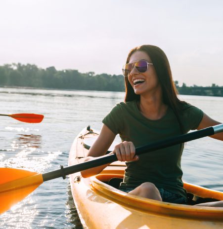 woman smiling in a kayak